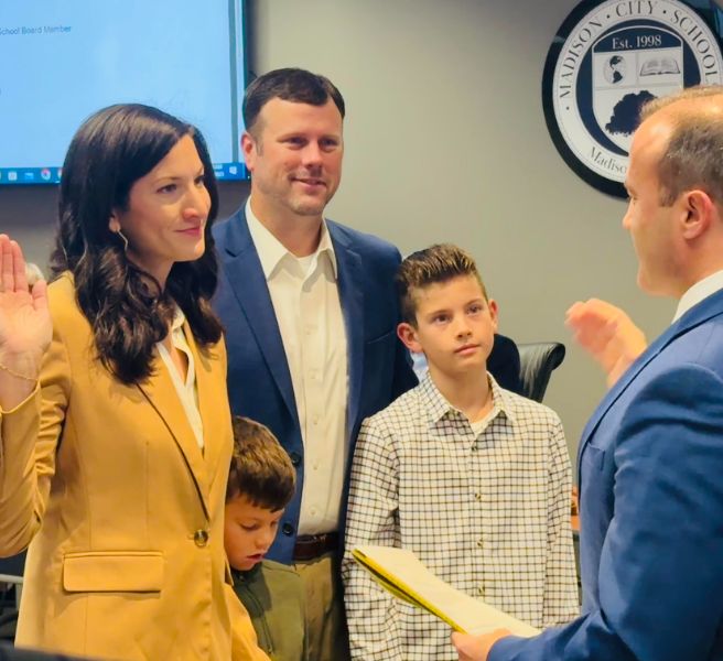  Tess Halbrooks being sworn in by municipal judge with husband and two sons at her side